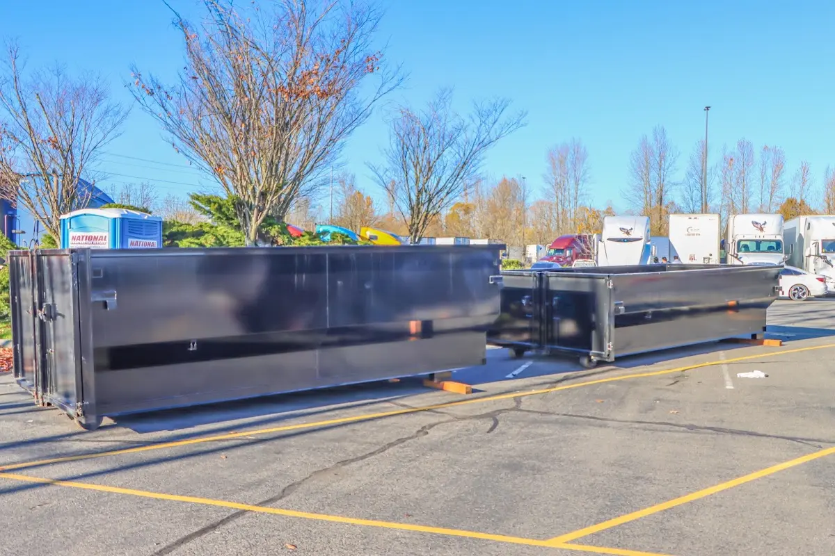 Professional dumpster rental service with roll-off container on residential driveway in Benson